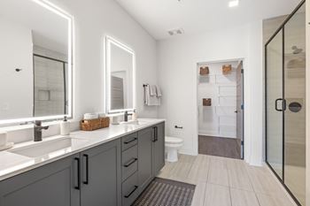 Cream tile flooring in bathrooms (b)